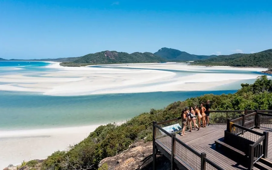 游客在 Hill Inlet 观景台，下方是 Whitehaven Beach